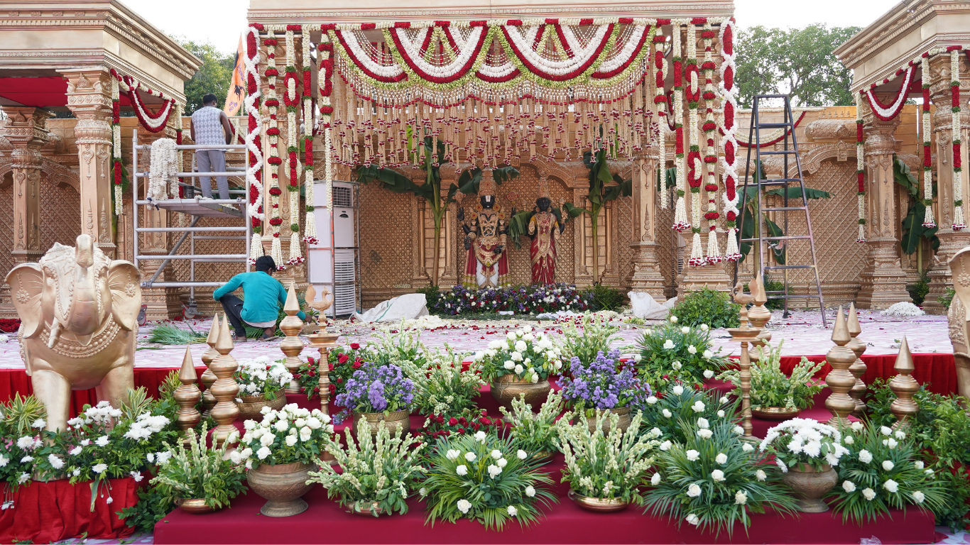 Full temple wedding stage decor with floral arrangements