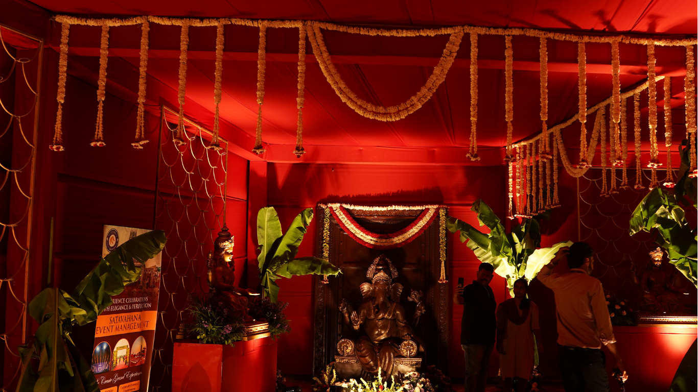 Ganesha shrine with jasmine garlands and red lighting