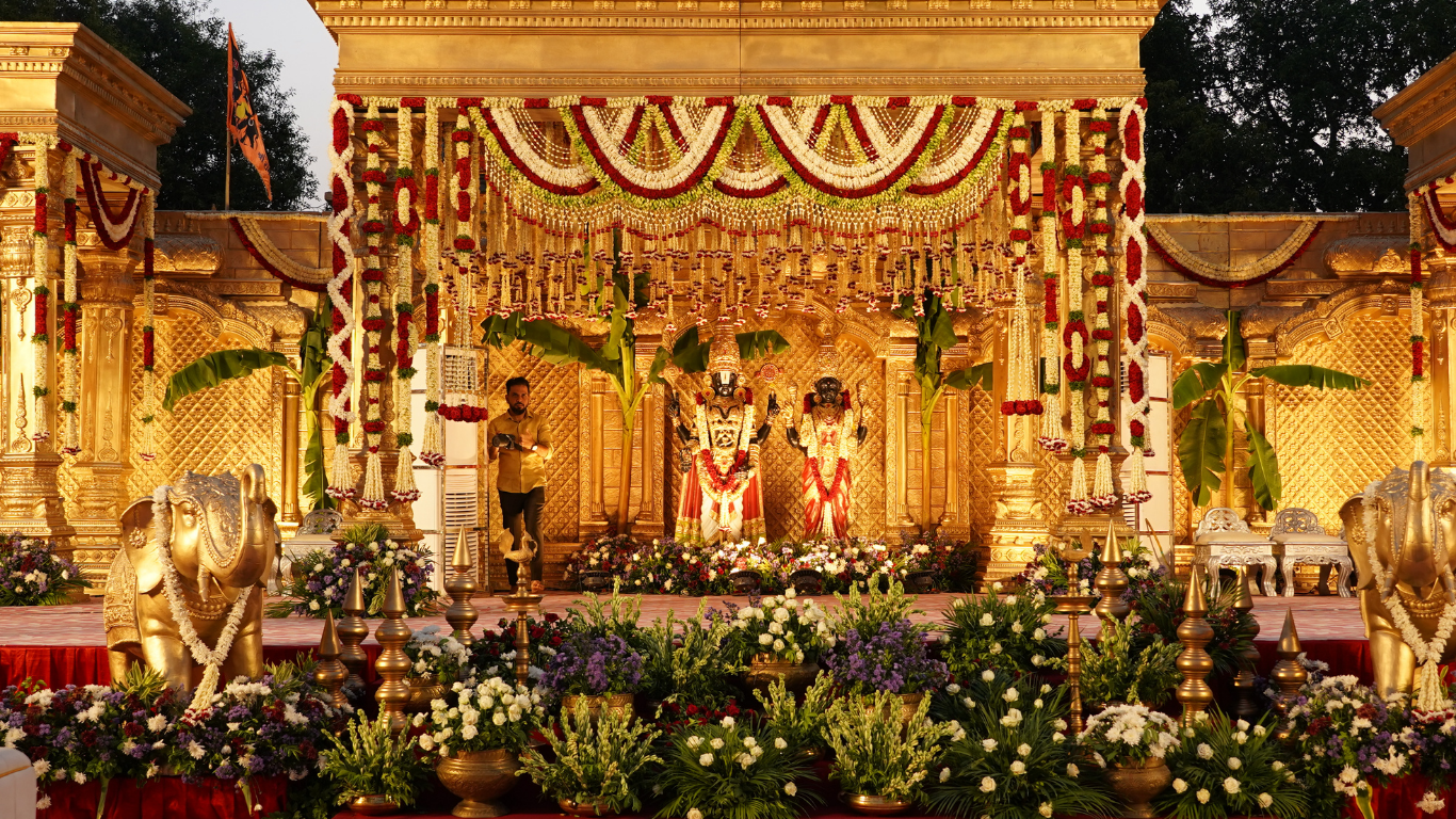 Grand golden wedding stage with floral garlands