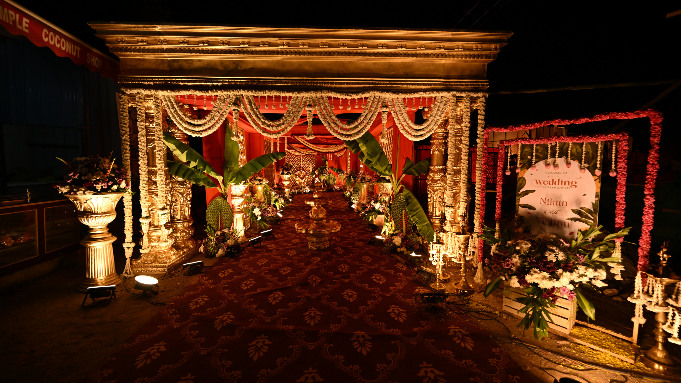 Grand wedding entrance with golden arch and welcome signage